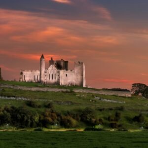 a castle sitting on top of a lush green hillside