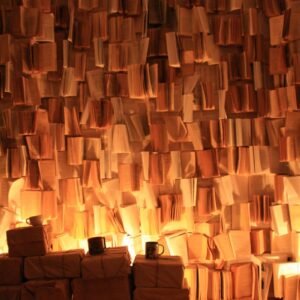 a room filled with stacks of books on top of a hard wood floor