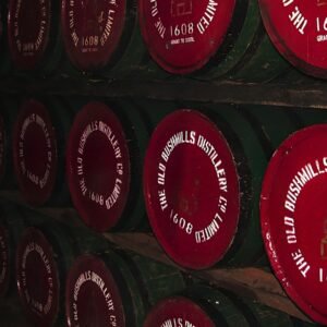 a row of wine barrels with labels on them