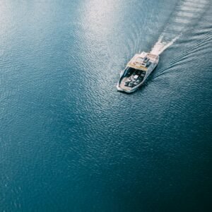 white and black boat on body of water during daytime