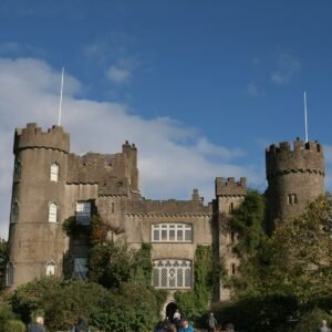 a group of people standing in front of a castle