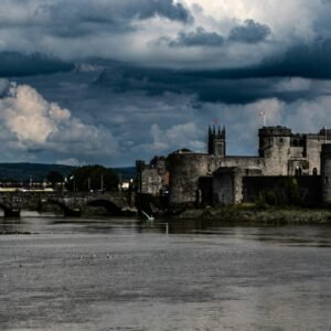 a castle on a hill by a river