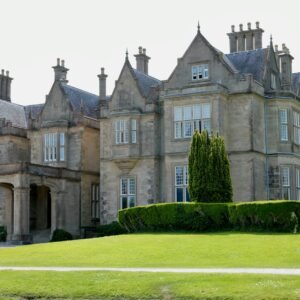 brown concrete building near green grass field during daytime